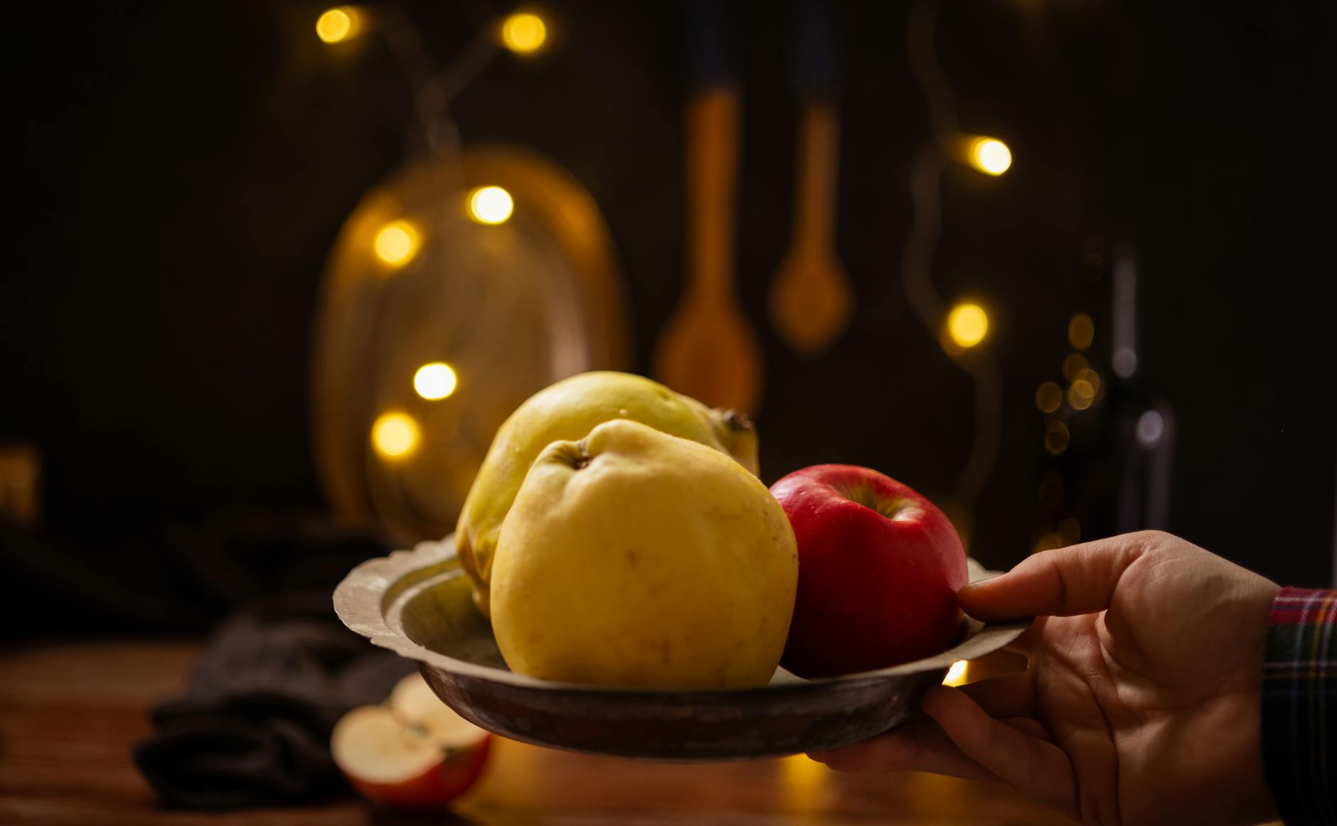 hand holding plate with fruit